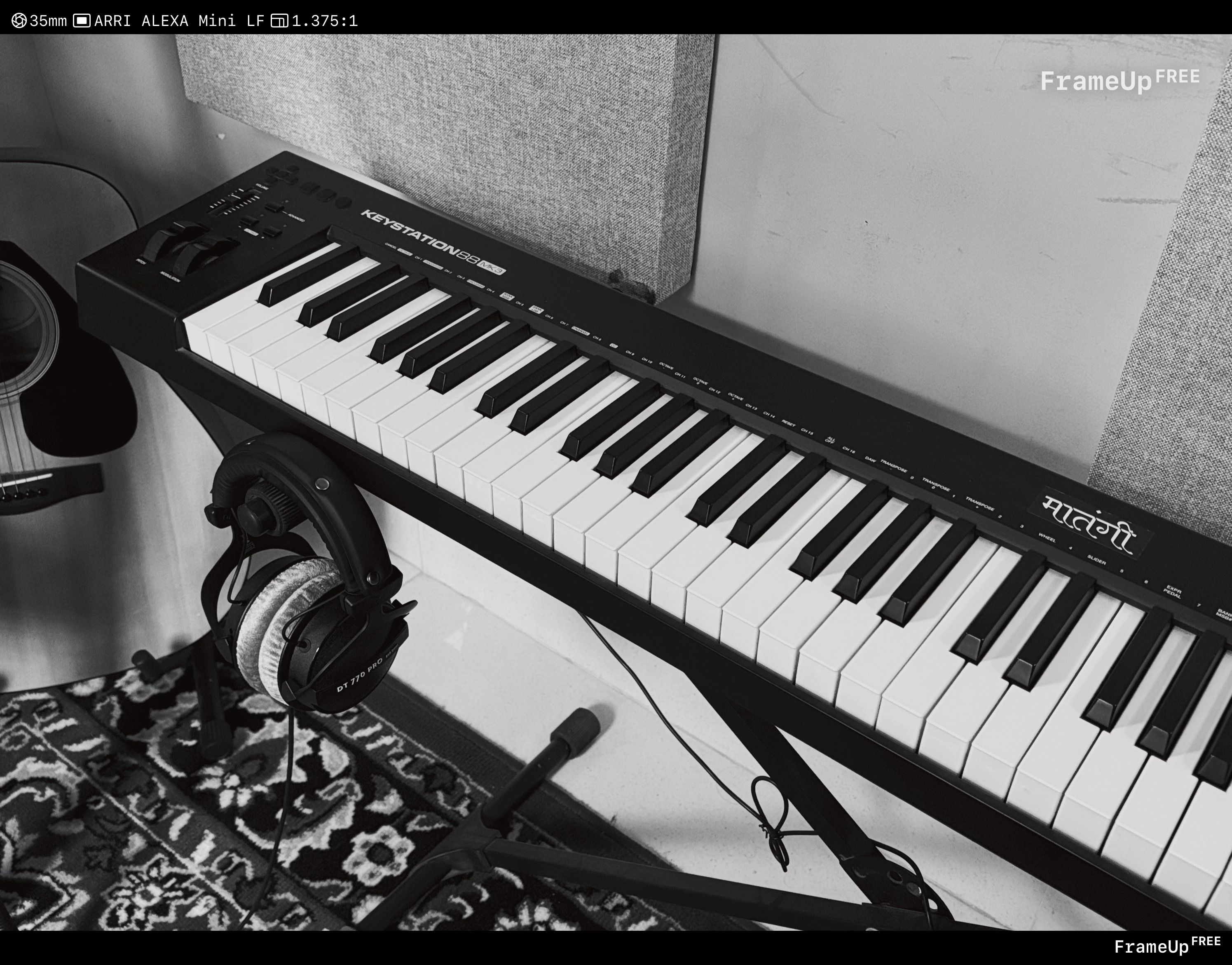 Harsh Parmar working at his studio setup, black and white